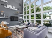 Thumbnail 44 of 56 - A living room with a grey couch, a yellow chair, and a coffee table at Madison at Eden Brook, 21046