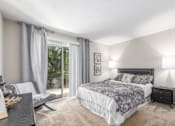 Thumbnail 24 of 56 - A bedroom with a large bed and a window with curtains at Madison at Eden Brook, 21046