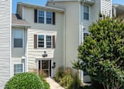 Thumbnail 52 of 56 - A white house with a brown door and windows at Madison at Eden Brook, 21046