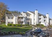 Thumbnail 54 of 56 - A row of townhouses with cars parked in front at Madison at Eden Brook, 21046