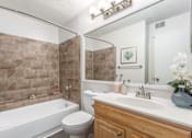 Thumbnail 29 of 56 - A bathroom with a white tub, sink, and toilet at Madison at Eden Brook, 21046