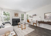 Thumbnail 3 of 56 - A living room with a fireplace and a white couch at Madison at Eden Brook, 21046