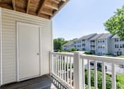 Thumbnail 53 of 56 - A white door is on a porch with a railing at Madison at Eden Brook, 21046