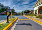 Thumbnail 34 of 34 - an empty street in a town with buildings and a street sign at MetroPlace at Town Center, Camp Springs