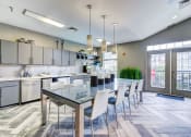 Thumbnail 22 of 34 - a large kitchen with a long table and chairs at MetroPlace at Town Center, Camp Springs, 20746