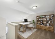 Thumbnail 8 of 34 - a home office with a desk and a book shelf at MetroPlace at Town Center, Maryland, 20746