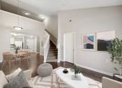 Thumbnail 7 of 34 - an open living room and dining room with a staircase in a home at MetroPlace at Town Center, Maryland