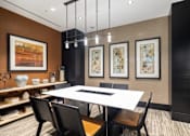 Thumbnail 24 of 84 - A modern dining room with a white table and black chairs at Mira Upper Rock, Maryland, 20850