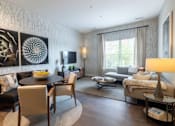 Thumbnail 8 of 84 - A modern living room with a dining table and chairs at Mira Upper Rock, Maryland, 20850