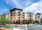 Thumbnail 83 of 84 - A large apartment building with a crosswalk in front of it at Mira Upper Rock, Maryland, 20850