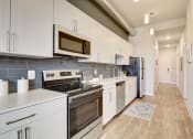 Thumbnail 17 of 34 - Model Kitchen at The Oxford Apartments, Oxon Hill Maryland