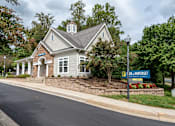 Thumbnail 11 of 18 - Clubhouse exterior with stone accents and cupola at Park at Winterset Apartments, Owings Mills, Maryland