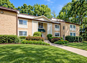 Thumbnail 16 of 18 - A building with a green lawn in front.