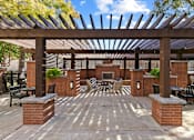 Thumbnail 22 of 24 - A patio with a table and chairs under a wooden pergola at Prairie Crossing, Texas