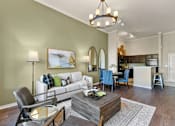 Thumbnail 2 of 24 - A living room with a white couch and a coffee table at Prairie Crossing, Farmers Branch, TX 75244