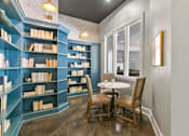 Thumbnail 12 of 24 - A room with a table and chairs and a bookshelf at Prairie Crossing, Farmers Branch, 75244