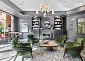 Thumbnail 7 of 24 - A modern living room with green chairs and a fireplace at Prairie Crossing, Farmers Branch, TX