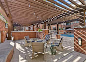 Thumbnail 23 of 24 - A patio with a table and chairs under a wooden pergola at Prairie Crossing, Texas 75244