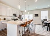 Thumbnail 8 of 30 - Kitchen with Island and Bar Stools at Refinery Row, Maryland