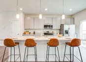Thumbnail 6 of 30 - Kitchen Bar with Brown Stools at Refinery Row, Baltimore, MD