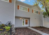 Thumbnail 47 of 54 - the front of a gray house with a sidewalk and a tree at Villages at Morgan Metro, Landover Maryland