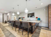 Thumbnail 29 of 54 - a long bar with chairs and a counter top in a lobby at Villages at Morgan Metro, Landover