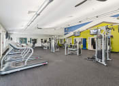 Thumbnail 22 of 54 - a gym with cardio equipment and weights on the floor at Villages at Morgan Metro, Landover, Maryland