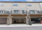 Thumbnail 25 of 30 - the front of a condo building with two garage doors at Refinery Row, Baltimore