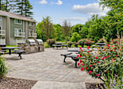 Thumbnail 21 of 40 - Outdoor patio with built in grills and benches at The Brook At Columbia Apartments, Maryland, 21044