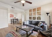 Thumbnail 9 of 33 - A living room with a grey couch and a coffee table at Riviera Park, Chandler Arizona