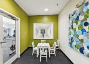 Thumbnail 26 of 54 - a dining room with a table and chairs and a painting on the wall at Villages at Morgan Metro, Landover, Maryland, 20785