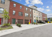 Thumbnail 29 of 30 - a red brick apartment building with a street in front of it at Refinery Row, Baltimore, 21224