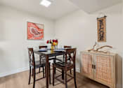 Thumbnail 11 of 33 - A dining room with a wooden table and chairs at Riviera Park, Chandler Arizona