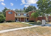 Thumbnail 42 of 54 - the front of a brick house with a lawn and trees at Villages at Morgan Metro, Maryland, 20785