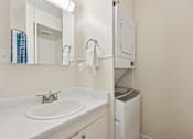 Thumbnail 18 of 33 - A bathroom with a white sink and a white trash can at Riviera Park, Chandler Arizona