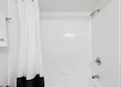 Thumbnail 11 of 40 - White subway tile bathroom with shower and tub at The Brook At Columbia Apartments, Maryland, 21044