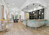 Thumbnail 33 of 45 - A modern bar area with a curved counter and blue chairs  at Poplar Glen Apartments, Columbia, MD, 21044.
