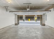 Thumbnail 26 of 30 - a empty parking garage with white walls and a yellow mailbox at Refinery Row, Baltimore, MD