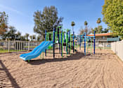 Thumbnail 31 of 33 - A playground with a blue slide and green monkey bars at Riviera Park, Chandler Arizona