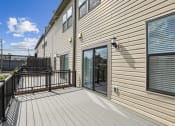 Thumbnail 23 of 30 - the deck of a home with a large window and a balcony at Refinery Row, Baltimore, Maryland