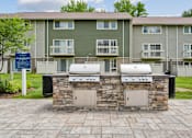 Thumbnail 22 of 40 - Stone builtin grilling stations with storage at The Brook At Columbia Apartments, Columbia, 21044