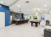 Thumbnail 18 of 54 - a clubhouse with a pool table and a bar and a tv at Villages at Morgan Metro, Landover, MD, 20785