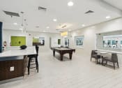 Thumbnail 19 of 54 - a game room with a pool table and a bar at Villages at Morgan Metro, Landover, Maryland, 20785