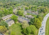 Thumbnail 33 of 40 - Aerial view of apartment community with parking and greenery at The Brook At Columbia Apartments, Maryland