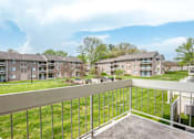 Thumbnail 17 of 40 - Balcony overlooking courtyard with apartment buildings at The Brook At Columbia Apartments, Columbia, MD 21044