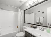 Thumbnail 21 of 46 - A white bathroom with a toilet, sink, and bathtub.