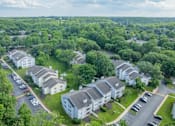Thumbnail 46 of 46 - A bird's eye view of a residential area with houses and parked cars.