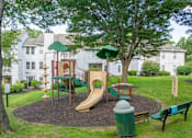 Thumbnail 43 of 46 - A playground with a slide, swings, and a climbing frame.