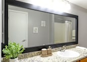 Thumbnail 81 of 81 - A bathroom with a sink, mirror, and a potted plant.