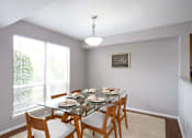 Thumbnail 13 of 65 - A dining room with a glass table and chairs.